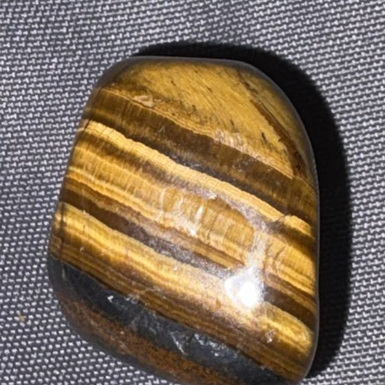 A polished tiger&rsquo;s eye stone