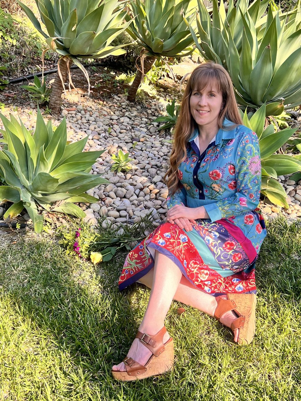 Heather Logghe, MD, seated among agave plants in a garden