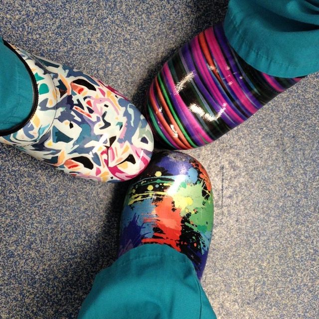 Three pairs of brightly patterned surgical clogs