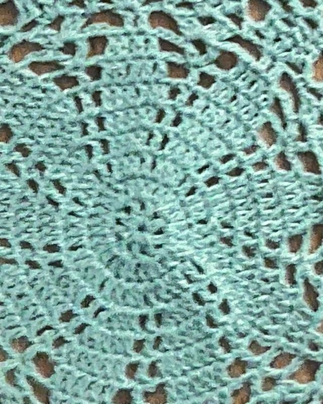 A hand-crocheted teal doily
