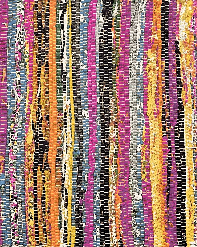A rag rug woven from strips of fuchsia, orange, gold, sky-blue, and plum fabric